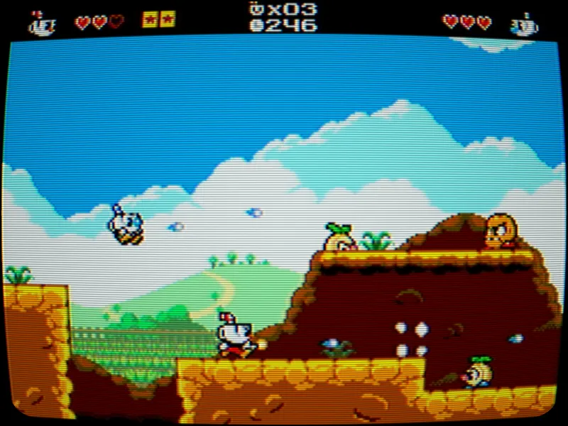Mighty Cuphead Adventure montrant Cuphead dans un niveau 8-bit en défilement latéral