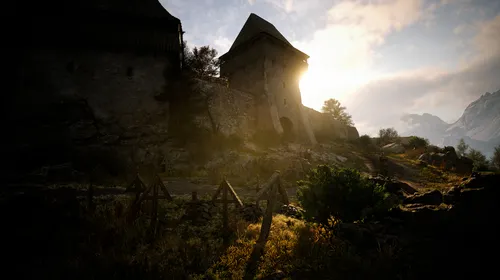 The Blood of Dawnwalker gameplay montre une forteresse baignée de lumière au cœur du monde ouvert