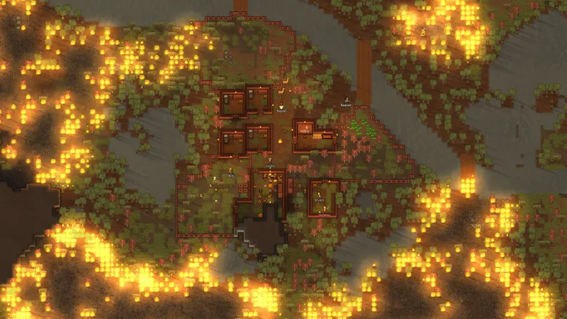 Incendie autour d’une base RimWorld montrant pourquoi le frigo et les réserves doivent rester protégés des murs en bois