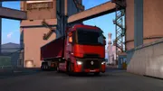 Euro Truck Simulator 2 montrant un camion roulant sur une autoroute au coucher du soleil