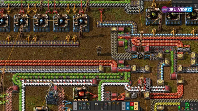 Usine Factorio montrant un bus principal de tapis rouges, verts et blancs pour organiser les ressources vers les premières chaînes de science