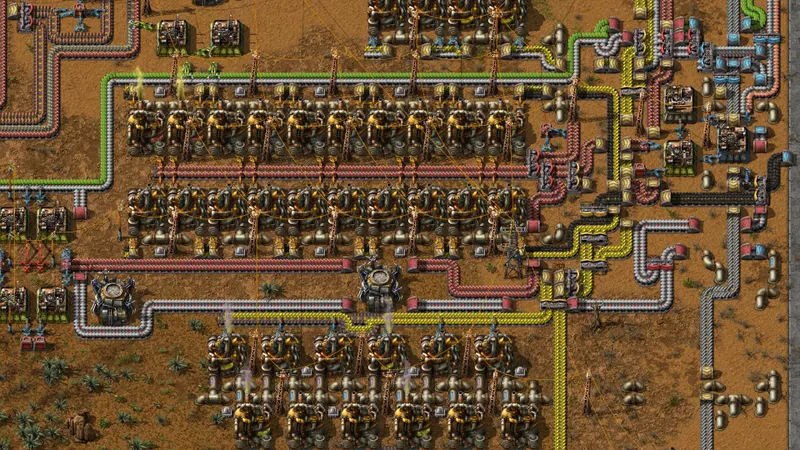 Base Factorio organisée avec tapis de ressources et production modulaire montrant une progression lisible après la stabilisation de la défense